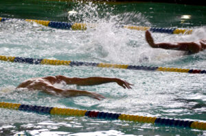 Swimmers in the pool seperated by bouys