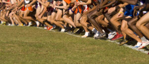 Boys Cross Country runnning on a filed